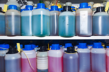 Sealed bottles of fuel and petrol samples standing on the shelves.