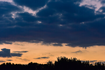 The sunset background creates a beautiful scenery with the suspension bridge and river