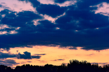 The sunset background creates a beautiful scenery with the suspension bridge and river
