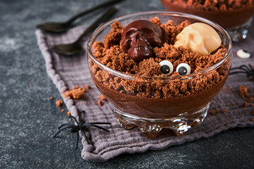 Halloween party chocolate puddings or Panna Cotta with brownie crumbles and chocolate sculls served...