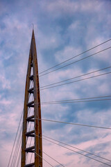 Obraz premium The sunset background creates a beautiful scenery with the suspension bridge and river