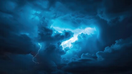Obraz premium dramatic lightning and thunder striking a deep blue sky, illuminating the clouds and creating a sense of awe and power in a stormy atmosphere