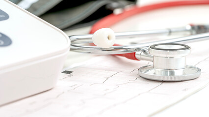 stethoscope on heart cardiogram