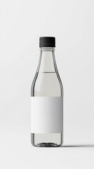 A clear glass beverage bottle with a minimalist label and a black cap on a solid white background