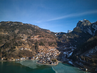 Bird's eye view of the Lago di Alleghe and Alleghe village in Dolomites, Italy