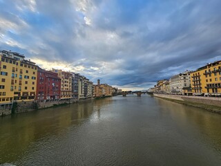Florence, Italy - October 5, 2024: Discovering the city of Florence in autumn days. Frome the Duomo to Ponte Vecchio, old architecture covering the city. Beautiful sky reflected over Arno river.