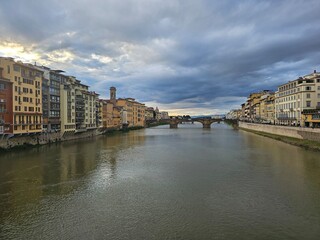 Florence, Italy - October 5, 2024: Discovering the city of Florence in autumn days. Frome the Duomo to Ponte Vecchio, old architecture covering the city. Beautiful sky reflected over Arno river.
