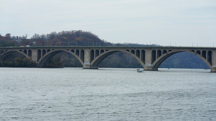 One arched bridge cross the wide river in the city of Washington DC