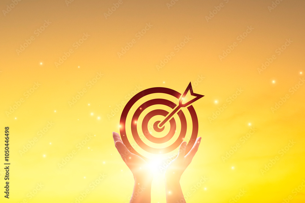 Aufkleber silhouette of hand holding dartboard arrow on sunrise background for enhance and setup business obje
