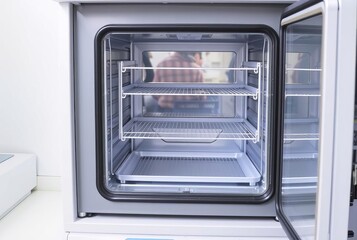 Lab Oven A laboratory oven with its door ajar showing empty shel
