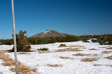 Mount Sněžka in the Karkonosze Mountains features an observatory at its peak, straddling the...