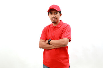 Professional happy delivery employee man wear red cap t-shirt uniform workwear work as dealer courier hold hands crossed folded isolated on white background studio. Service concept