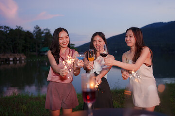 Asian women celebrating, meeting and chatting in a bar. Places to visit, beautiful lights