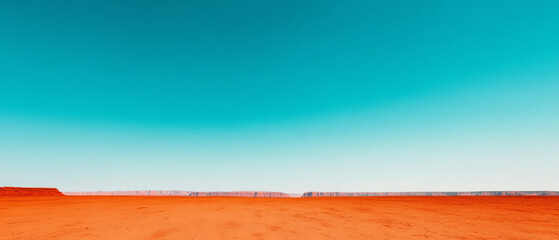 Vast desert landscape with vibrant orange earth and a bright blue sky, capturing the serene beauty of nature's color contrast.