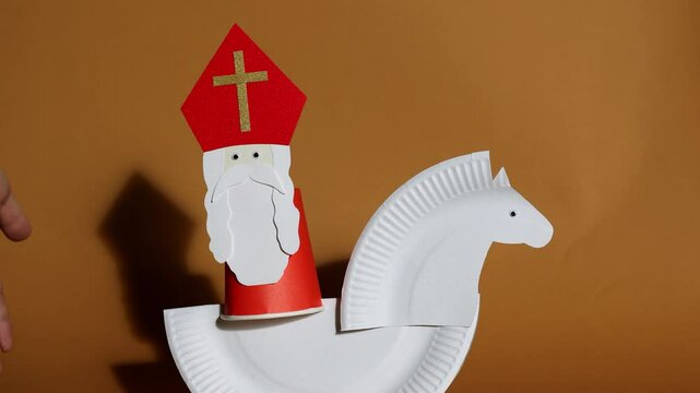 paper craft from paper plates and glasses for kids. DIY toy Saint Nicholas and white horse for sinterklaas day. create art for children. Netherlands Santa Claus