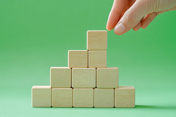 Strategic Collaboration Building Success with Wooden Blocks Against Pastel Green Background