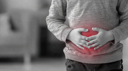 Child holding stomach with red inflamed area indicating abdominal pain or cramps in grayscale tone