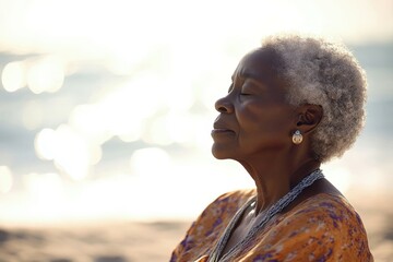 Senior black woman breathing fresh air and enjoying her retirement at the beach