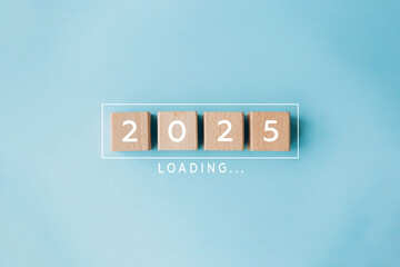 2025 New Year Loading. Loading bar with wooden blocks 2025 on blue background. Start new year 2025 with goal plan, goal concept, action plan, strategy, new year business vision.
