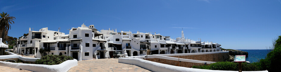 Panoramic view of Binibeca or Binibequer Vell. Urbanization on the island of Menorca, imitating the white houses of fishermen. Balearic Islands