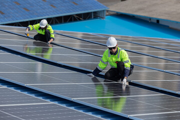 Engineer checking on solar panel on the factory rooftop