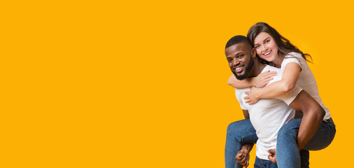 Happy Together. Romantic Black Man Piggybacking His Girlfriend, Interracial Couple Posing Together...