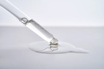 Dropper pipette with delicious serum with drop close-up.