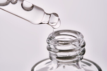 Close-up of a cosmetic bottle with a pipette showing the texture of the serum.