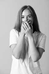 Lifestyles, horror concept. Black and white image of a woman with hands covering her mouth and...