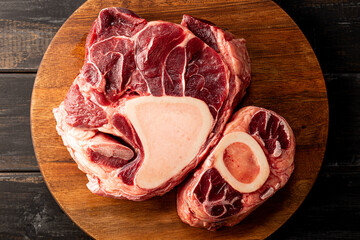 Raw osso buco beef on dark wooden background top view
