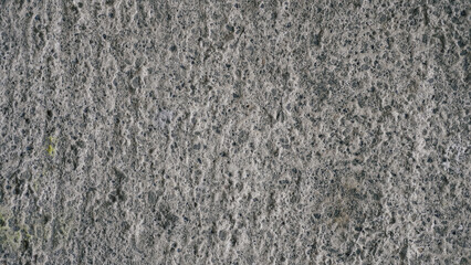 Close-up of rough gray concrete texture. Detailed stone-like surface, ideal for backgrounds, industrial themes, or raw material design elements