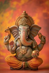 Fototapeta premium Vibrant image of a colorful ganesha statue against an orange background, radiating tradition and faith. Handmade indian art capturing spirituality and culture