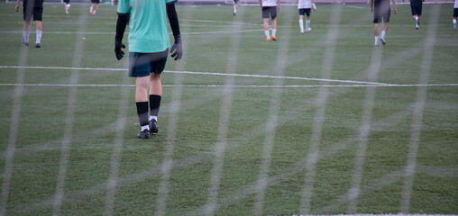 Football. The teams play football in the evening on the football field.