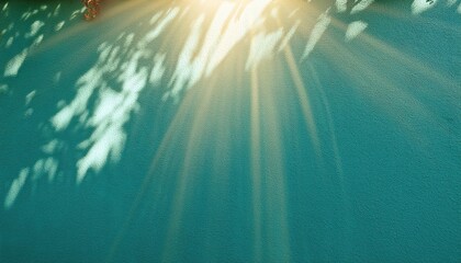 Fototapeta premium Radiant Golden Sunlight Beams Spreading Across a Textured Turquoise Wall Background. Perfect for Inspirational Design, Wellness Branding, Spiritual Imagery, or Calming Visual Content
