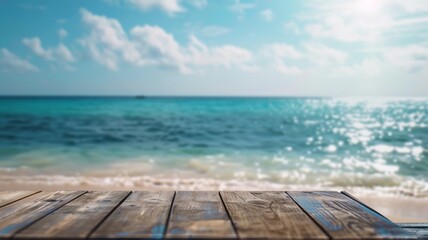 Empty wooden table with blurred tropical beach background for product display concept.