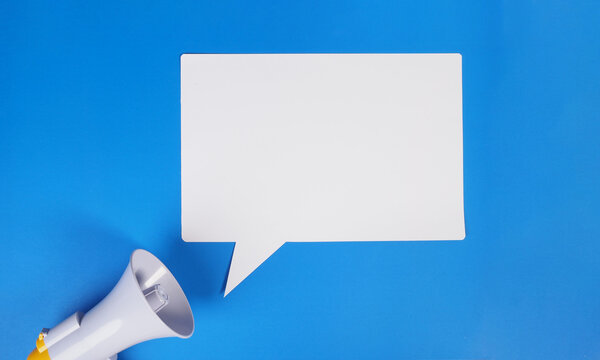Speech bubble and megaphone on blue background