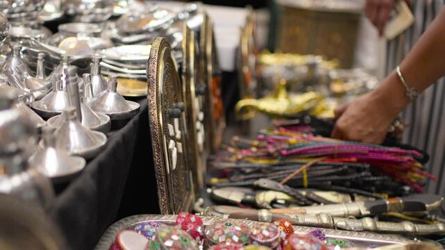 hands of woman touching knick-knacks trinkets in Marrakech medina Moroco.MOV