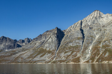 View of icebergs and mountains in the fjords of south Greenland