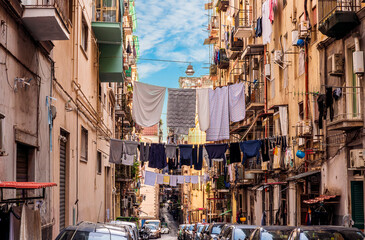 city view of old down town street of slum area with vintage facades of buildings and drying clothes...