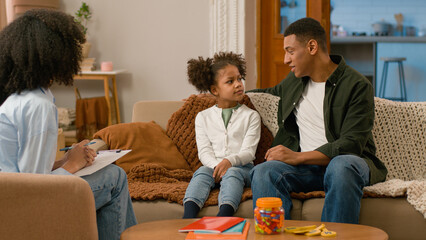 African American family together psychologist doctor writing man father dad tell parenting...