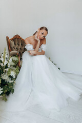 Portrait of a cute adult girl in a modern stylish wedding dress. Wedding trends 2024 2025.