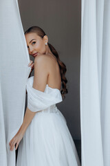 Portrait of a cute adult girl in a modern stylish wedding dress. Wedding trends 2024 2025.