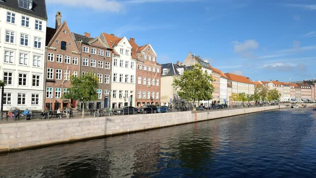 View of colorful houses in the capital of the country. The lake is long. Many tourists in this city. Copenhagen, DENMARK. OCTOBER 20, 2024