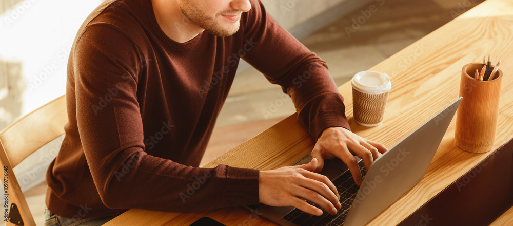 Poster copywriting. unrecognizable freelancer guy using laptop writing article for website working at workp