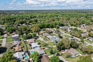 Aerial view of Ormond Beach, Florida suburban neighborhood houses and trees.	