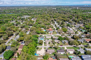Aerial view of Ormond Beach, Florida suburban neighborhood houses and trees. 