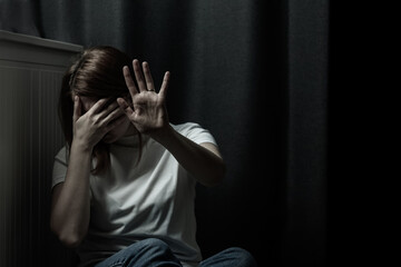 The woman in the photo looks depressed and scared, she has suffered from domestic violence or...