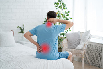 Back and neck pain, lumbar and cervical spine hernia, man with backache at home