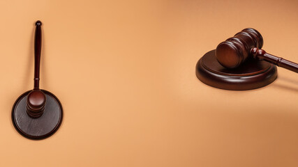Gavel down on stand on brown background. Justice of law system conceptual.