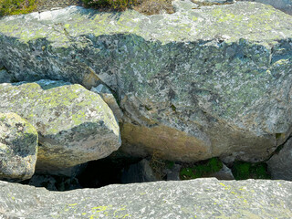 A large pile of various rocks that are sitting on top of a concrete surface
